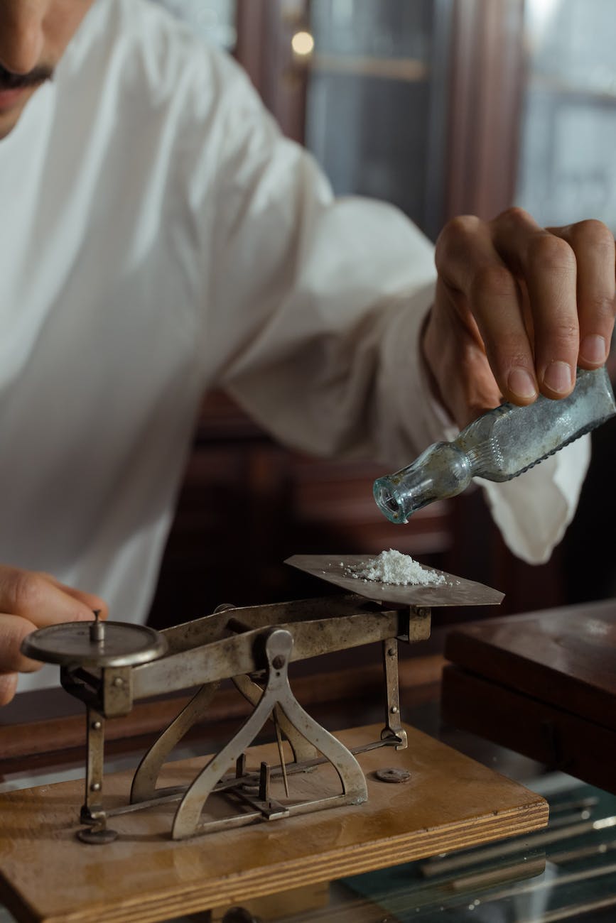 a man holding weighing white powder