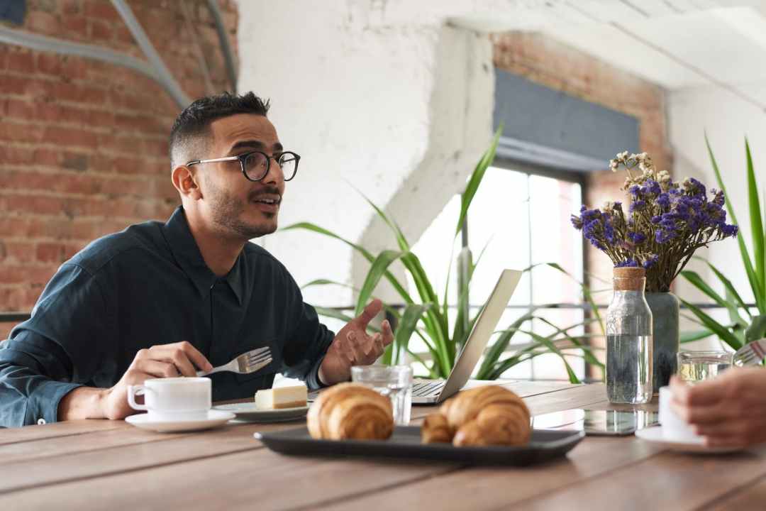 photo of man in front of his laptop